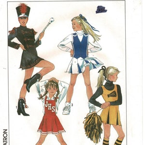 May include: A white ceramic mug with a black handle and the text "But First, Coffee" in a bold, black font. The mug is filled with a dark liquid, likely coffee, and sits on a light-colored surface.