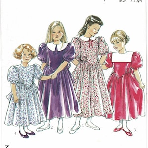 May include: Image of a pattern for girls' dresses. The dresses feature puff sleeves, white collars, and various colors and patterns, including floral and solid hues. The age range is 3-10 years. The dresses have a vintage style.
