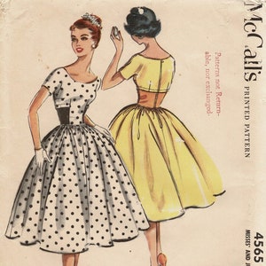 May include: Vintage sewing pattern featuring two dresses. One dress is white with black polka dots, a black waist, and a full skirt. The other is yellow with a fitted bodice and a full skirt. The pattern is labeled "McCall's" and includes the number 4565.