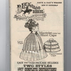 May include: Vintage sewing pattern for a cape, featuring a detailed illustration of a woman wearing a lacy cape and a three-tiered cape. The pattern is from Buckaroo Bobbins, with text that reads "Save a Day's Wages, Sew it Yourself."