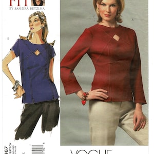 May include: A sewing pattern envelope for Vogue Patterns V2967 Today's Fit by Sandra Betzina. The cover features a long-sleeved red top with a diamond-shaped cutout at the neckline and a short-sleeved blue top illustration with similar details.