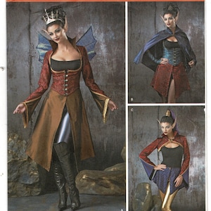 May include: Simplicity pattern 1138 for costumes in sizes U.S. 6, 8, 10, 12. The envelope displays three variations of a fantasy-themed outfit featuring a red patterned bodice, a brown skirt, a blue cape, and gold leggings, all worn with pointed ears.