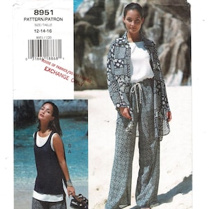 May include: A woman models a three-piece outfit: a white top, patterned jacket, and matching pants. The jacket and pants feature a blue and white floral design. The image also includes a pattern envelope with the number 8951 and the text "EXCHANGE ONLY."