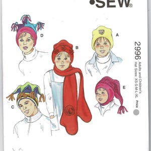 May include: Kwik Sew pattern 2996 for adults and children's hats in sizes XS-S-M-L-XL. The envelope features illustrations of five hat styles labeled A through E, including a yellow beanie, a red hat with a matching scarf, and multi-colored caps.