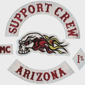 May include: A set of embroidered patches featuring a white arched top rocker with red text reading SUPPORT CREW, a white bottom rocker with red text reading ARIZONA, a rectangular MC patch, a diamond 1% patch, and a central skull with flames.