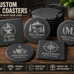 May include: A collection of square and circular black slate coasters with laser-engraved logos including Forge & Flame, Wildwood Cabin Co., Millstone Brewing, Oak & Bean Coffee Co., and North Ridge Outfitters, displayed with a black metal holder.