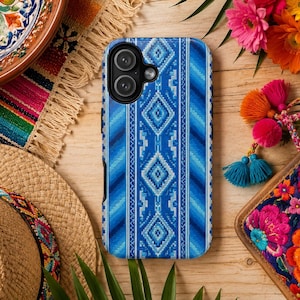 May include: A rectangular smartphone case featuring a vibrant blue geometric pattern with repeating diamond shapes and vertical stripes. The case has a black camera cutout area at the top left corner, showcasing a dual-lens camera configuration.