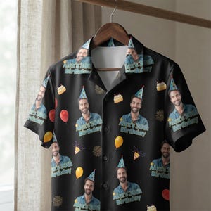 May include: A black short-sleeve button-down shirt featuring a repeating pattern of a man wearing a blue party hat, colorful balloons, birthday cakes, and fireworks. The text "Alex's 30th Birthday" is printed in light blue below each face.