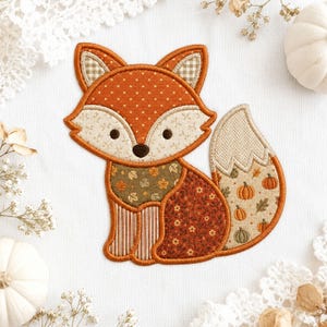 May include: An embroidered fox applique featuring a patchwork design with various fabric patterns including orange polka dots, cream floral prints, brown leaves, stripes, and a tail decorated with small pumpkins and herringbone textures.