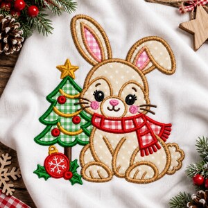 May include: An embroidered design on white fabric featuring a beige polka-dot rabbit with pink-lined ears wearing a red and white checkered scarf. Beside the rabbit is a green checkered Christmas tree with a yellow star and a red ornament.