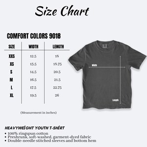 May include: A size chart for a Comfort Colors 9018 youth t-shirt, displaying a dark gray shirt with width and length indicators. The table lists sizes XXS through XL with corresponding measurements in inches. Text includes material details.