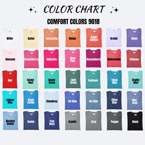 May include: A color chart for Comfort Colors 9018 t-shirts, displaying 35 folded shirts in various shades including white, butter, terracotta, melon, salmon, orchid, violet, blossom, pink, red, green, blue, grey, and black with labels.