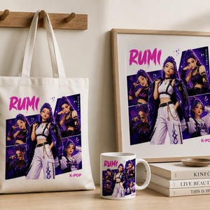 May include: A white canvas tote bag, a framed print, and a white ceramic mug, each featuring a graphic collage of a character named Rumi with purple hair, wearing a white crop top, black harness, and purple jacket, with the text Rumi and K-Pop.