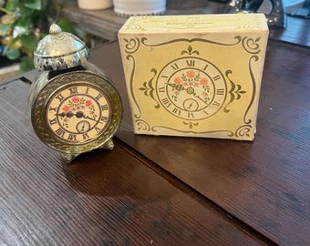 Botella con forma de reloj Beautiful Awakening de Avon con caja