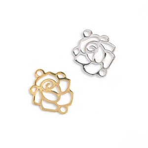 May include: Two metal rose-shaped charms, one gold and one silver. The charms are open and have a delicate, intricate design.