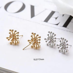 May include: Two pairs of stud earrings are displayed. One pair is gold, the other silver. Each earring has a spherical design with multiple small balls. The earrings measure 15.5 x 17mm.