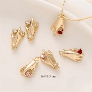 May include: Gold-tone metal hand charms with colorful gemstone accents. The charms are approximately 1.68 inches by 0.85 inches.