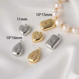 May include: Five different metal charms with a star-shaped rhinestone in the center. The charms are in the shapes of a heart, a teardrop, and a rectangle. The charms are 10mm x 15mm, 10mm x 16mm, and 11mm in size.