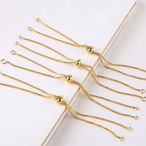 May include: A set of six gold-toned adjustable chain bracelet extenders. Each extender features a small, round bead and two loops at each end.