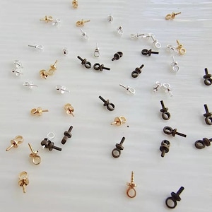 May include: Assortment of gold, silver, and black bead tips. The bead tips have a loop at the top and a post at the bottom. These bead tips are used for jewelry making.