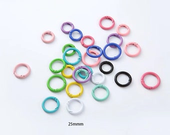 May include: Assortment of colorful metal key rings with a spring-loaded clasp. The key rings are approximately 25mm in diameter.