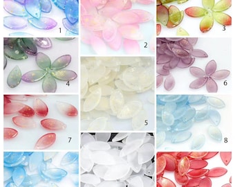 May include: A collection of translucent, petal-shaped beads in various colors, including blue, pink, green, and red. Some petals have a gradient effect and gold glitter accents. The beads are suitable for jewelry making and craft projects.