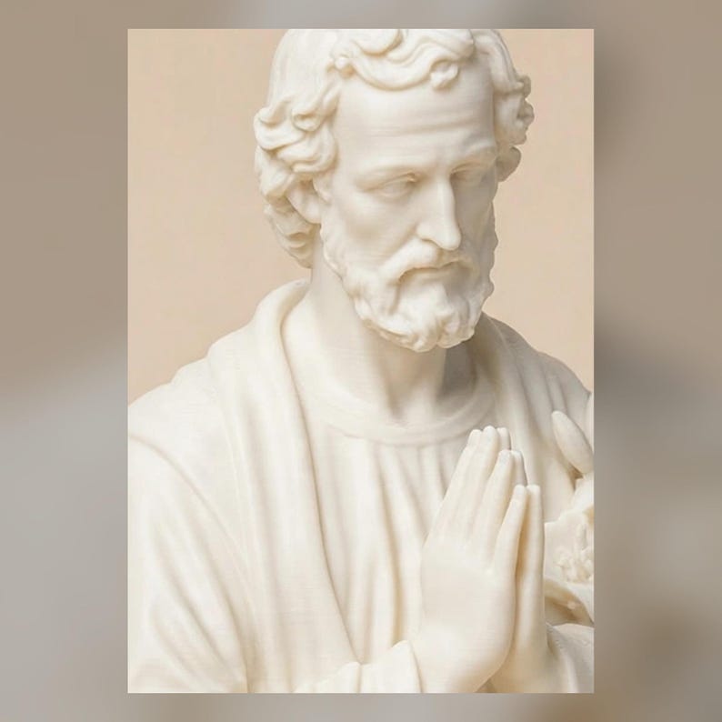 May include: A cream-colored bust sculpture of a bearded man with wavy hair, depicted with hands pressed together in a prayer position. The figure wears a draped garment over the shoulders and holds a lily flower visible near the hands.