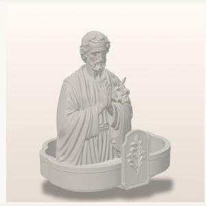 May include: A matte white resin sculpture of a bearded figure with hands clasped in prayer, wearing draped robes. The figure holds a lily branch and is set within a low, curved base featuring a relief of a lily flower on the front panel.