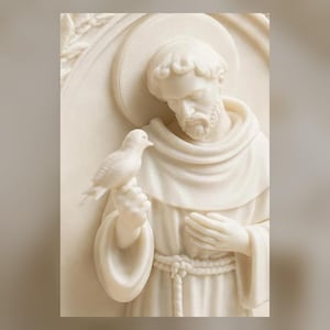 May include: A cream-colored relief sculpture depicting a bearded figure in a hooded robe with a halo, holding a small bird on one hand. The figure has a downward gaze, and the background features a circular arch design with subtle leaf detailing.