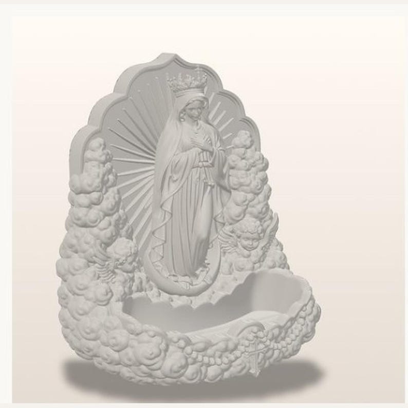 May include: A matte white wall-mounted holy water font featuring a central relief of a crowned figure with hands clasped in prayer, surrounded by sculpted clouds, sunburst rays, and cherub faces, with a basin at the base for holding liquid.