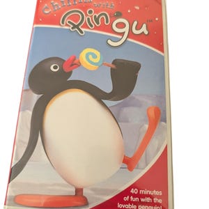 May include: A VHS tape titled Chillin' with Pingu featuring a black and white penguin character holding a colourful lollipop. The cover art includes red and blue sections with the text 40 minutes of fun with the lovable penguin! at the bottom.
