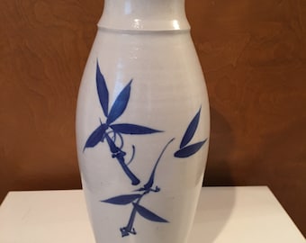 Tall ceramic vase with blue bamboos.