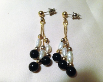 Onyx and pearl dangle earrings.
