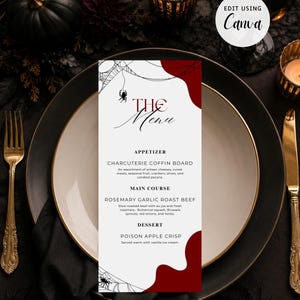 May include: A rectangular menu card with a white background, red abstract shapes, and black spiderweb and spider illustrations. The text reads THE MENU, APPETIZER CHARCUTERIE COFFIN BOARD, MAIN COURSE ROSEMARY GARLIC ROAST BEEF, and DESSERT POISON APPLE CRISP.