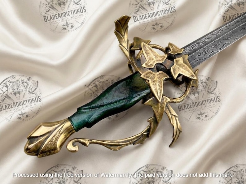 May include: A sword with a patterned Damascus steel blade and a dark green handle. The hilt features an ornate brass guard shaped like ivy leaves and vines, with a matching brass pommel at the base of the grip. The design is intricate and metallic.