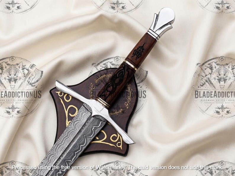 May include: A decorative sword featuring a patterned Damascus steel blade, a dark brown wooden handle with black etched detailing, and a polished silver-toned pommel and crossguard. The sword rests upon a dark brown wooden display plaque.