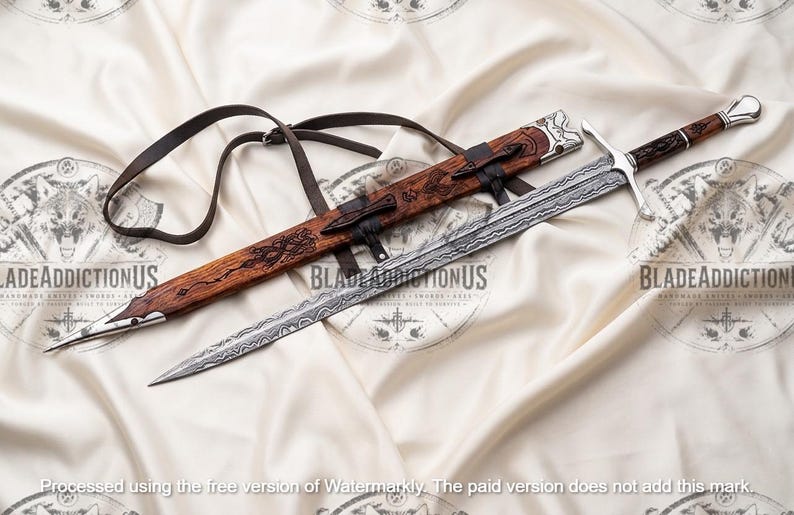 May include: A double-edged sword with a patterned Damascus steel blade, a silver crossguard, and a dark wood handle. It is accompanied by a matching wooden scabbard featuring intricate carvings, silver metal accents, and a black leather strap.