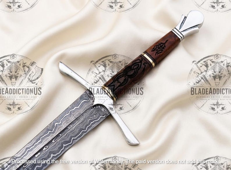 May include: A sword with a patterned Damascus steel blade featuring wavy lines. The hilt has a dark brown wooden handle with black etched designs, a silver-colored crossguard, and a silver-colored pommel. The handle includes gold-colored rings.