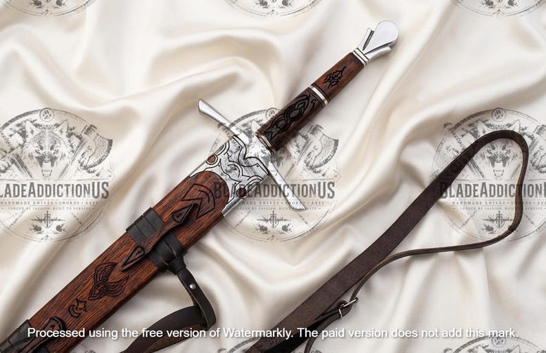 May include: A sword with a dark brown wooden handle and scabbard featuring intricate black engravings. The hilt has a silver-colored pommel and crossguard. A dark brown leather strap is attached to the scabbard. The text BLADEADDICTIONUS is visible.