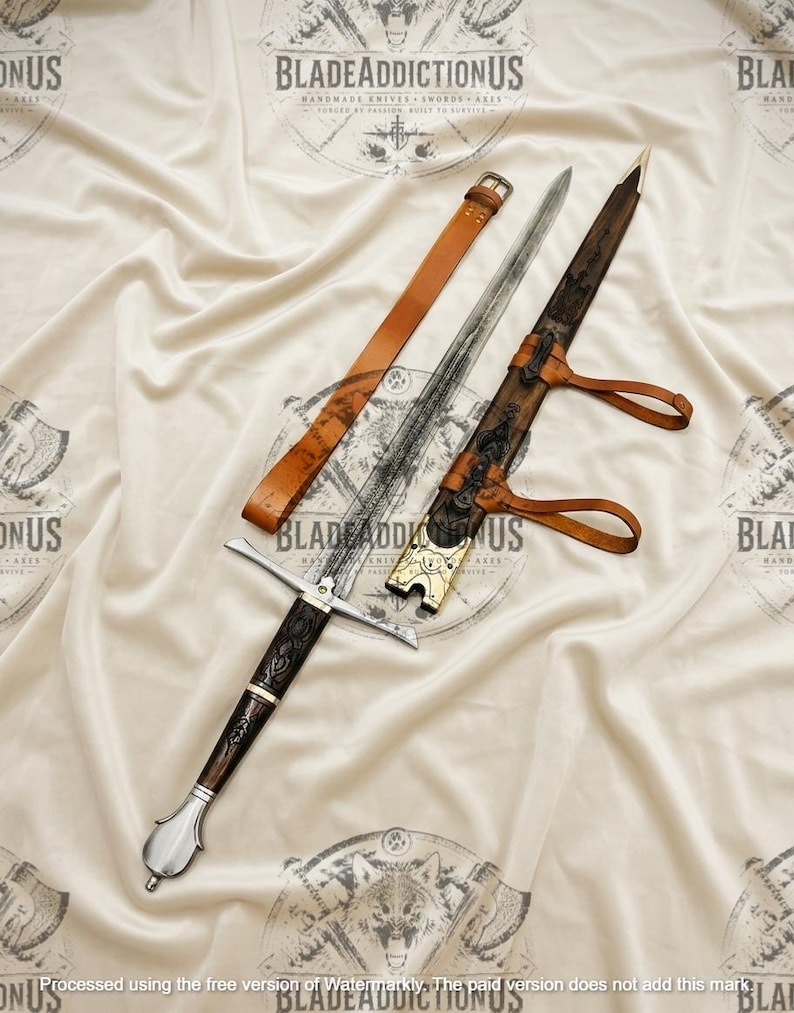 May include: A metal sword with a dark, textured handle and a silver pommel, accompanied by a wooden scabbard featuring intricate carvings and brass accents, along with a tan leather belt strap for carrying the weapon securely.