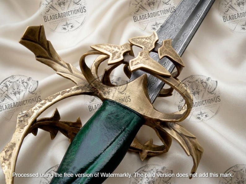 May include: A sword featuring a dark green handle and an intricate, weathered brass-toned metal hilt with leaf-like guard details. The blade displays a visible Damascus steel pattern, extending from the hilt toward the upper edge of the frame.
