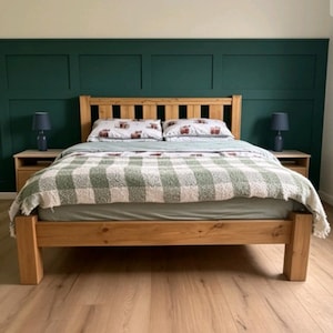 May include: A wooden bed frame with a slatted headboard, featuring a light wood finish. The bed is dressed with a light green fitted sheet, a white and green checkered blanket, and two pillows with a subtle pattern, flanked by two bedside tables.