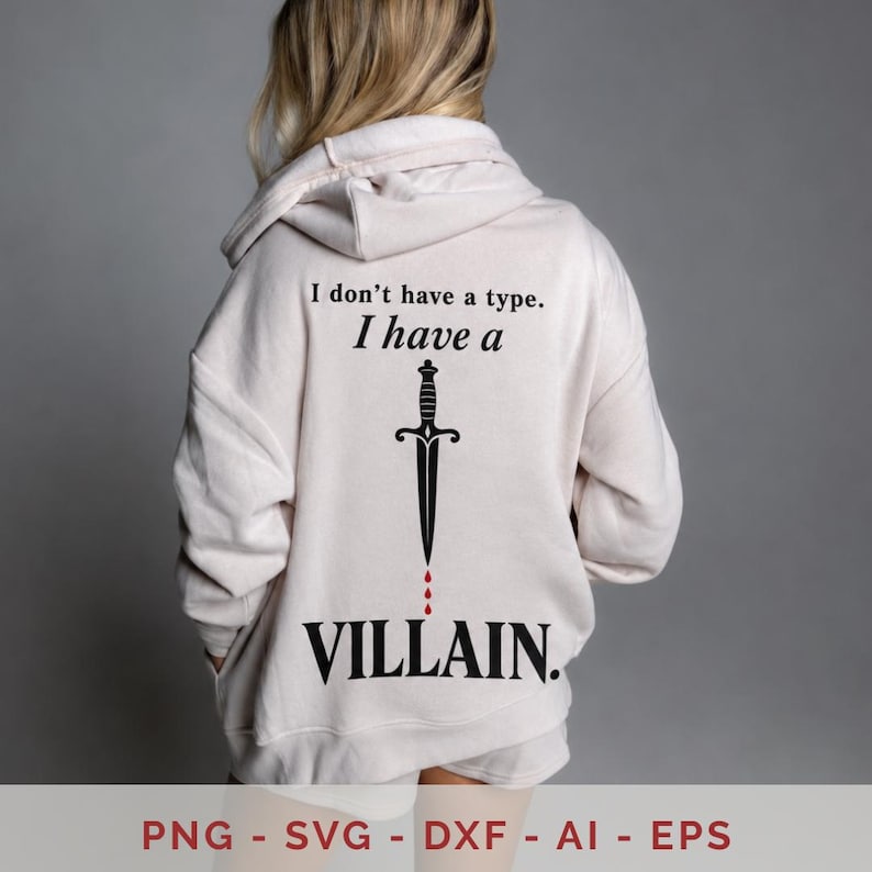 May include: A light beige hooded sweatshirt featuring black text on the back that reads I don't have a type. I have a VILLAIN. Below the text is a black dagger graphic with three small red droplets falling from the tip of the blade.