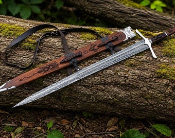 May include: A double-edged sword with a patterned Damascus steel blade, a silver crossguard, and a dark wood handle. The matching wooden scabbard features intricate carvings, silver metal accents, and a black leather shoulder strap for carrying.