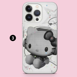 May include: A clear phone case featuring a black and white halftone graphic of Hello Kitty wearing headphones. The design includes small colorful stars and a chain necklace illustration. The text Hello Kitty is printed on the left side.
