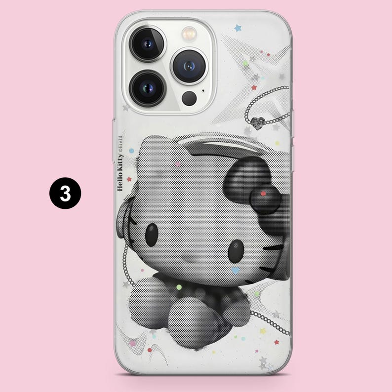 May include: A clear phone case featuring a black and white halftone graphic of Hello Kitty wearing headphones. The design includes small colorful stars and a chain necklace illustration. The text Hello Kitty is printed on the left side.
