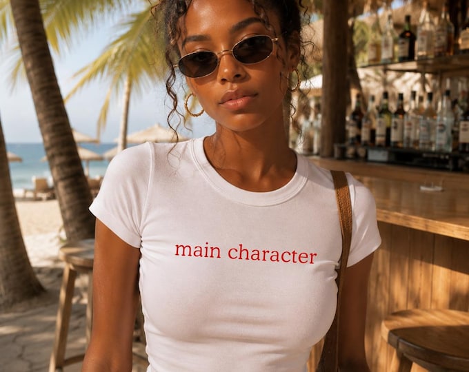 main character tee | Women's fitted t-shirt, red text, minimalist graphic