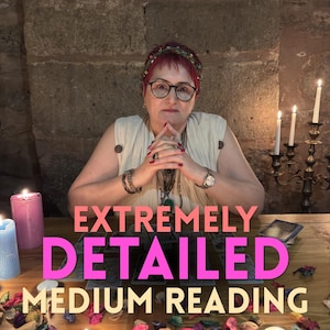 May include: A person with short red hair and glasses wearing a cream-coloured top, sitting behind a wooden table with tarot cards, candles, and scattered flower petals. The text "EXTREMELY DETAILED MEDIUM READING" is overlaid on the image.