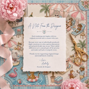 May include: A rectangular note with deckled edges featuring the text A Note From The Designer, placed over a colorful illustration of animals at a pool. A pair of gold-colored scissors rests on the right, with pink flowers in the corners.