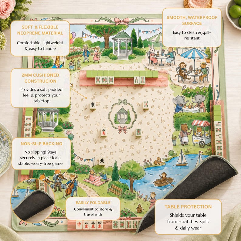 May include: A square mahjong mat featuring a colorful illustration of animals in a park with gazebos, trees, and a pond. The mat has a smooth, waterproof surface, a 2mm cushioned neoprene construction, and a non-slip black rubber backing.